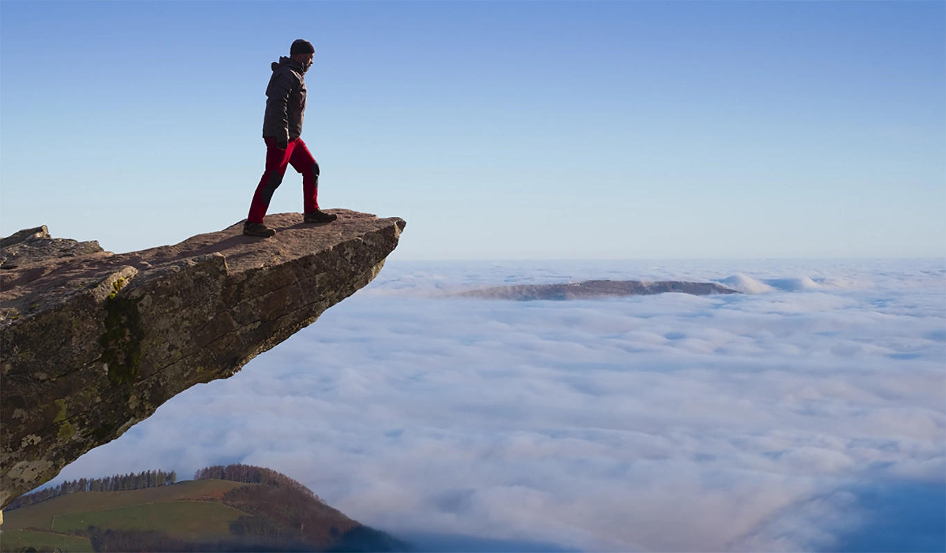 person at edge of overhang