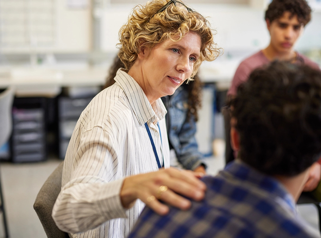 woman listening to young man in group setting