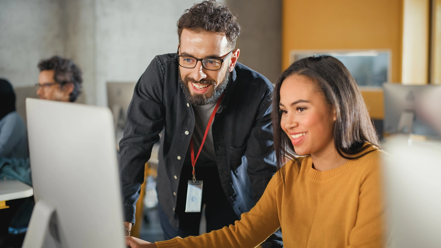 Instructor smiling at laptop