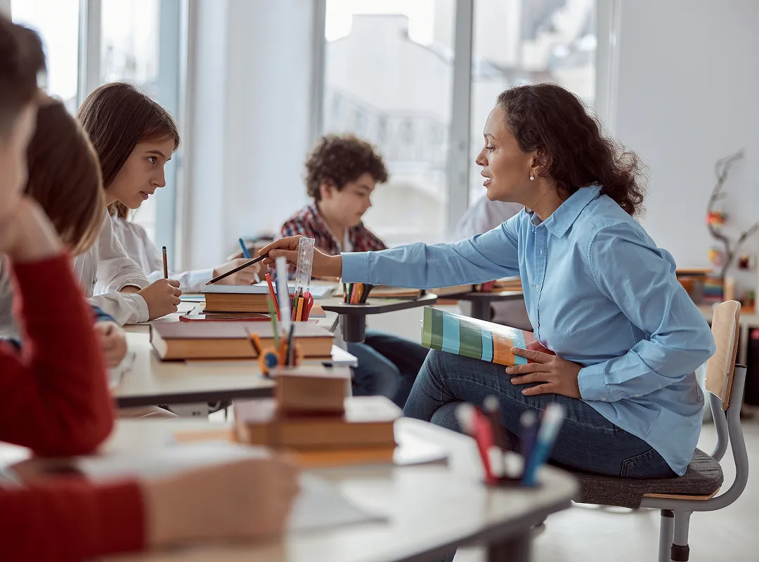 Teacher working with child who looks frustrated